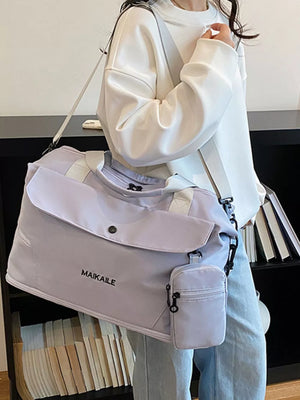 Lavender duffel bag with MAIKAILE logo and detachable pouch, worn with a white sweatshirt.