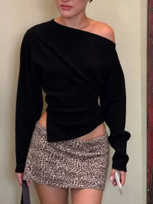 Black draped asymmetrical off-shoulder t-shirt with long sleeves.