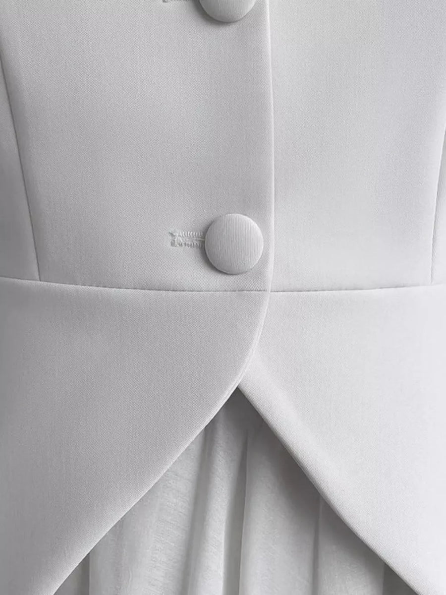 White formal jacket with two button closure and draped front detail.