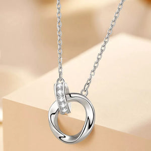 Silver necklace featuring pendant and interlocking circles