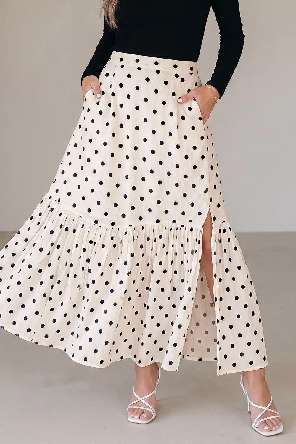 Beige polka dot ruffled maxi skirt with side slit and pockets.