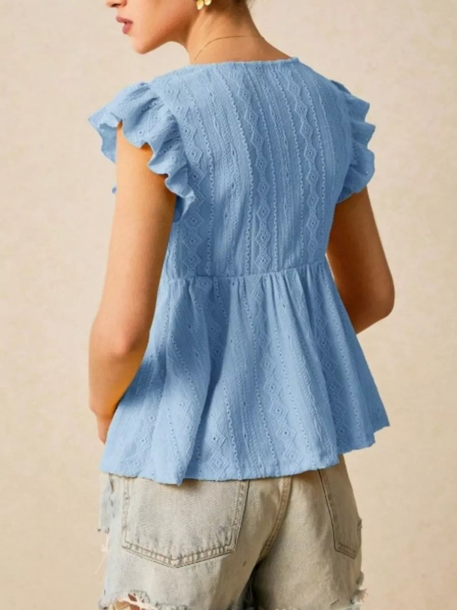 Light blue eyelet peplum blouse with ruffle sleeves and textured fabric.