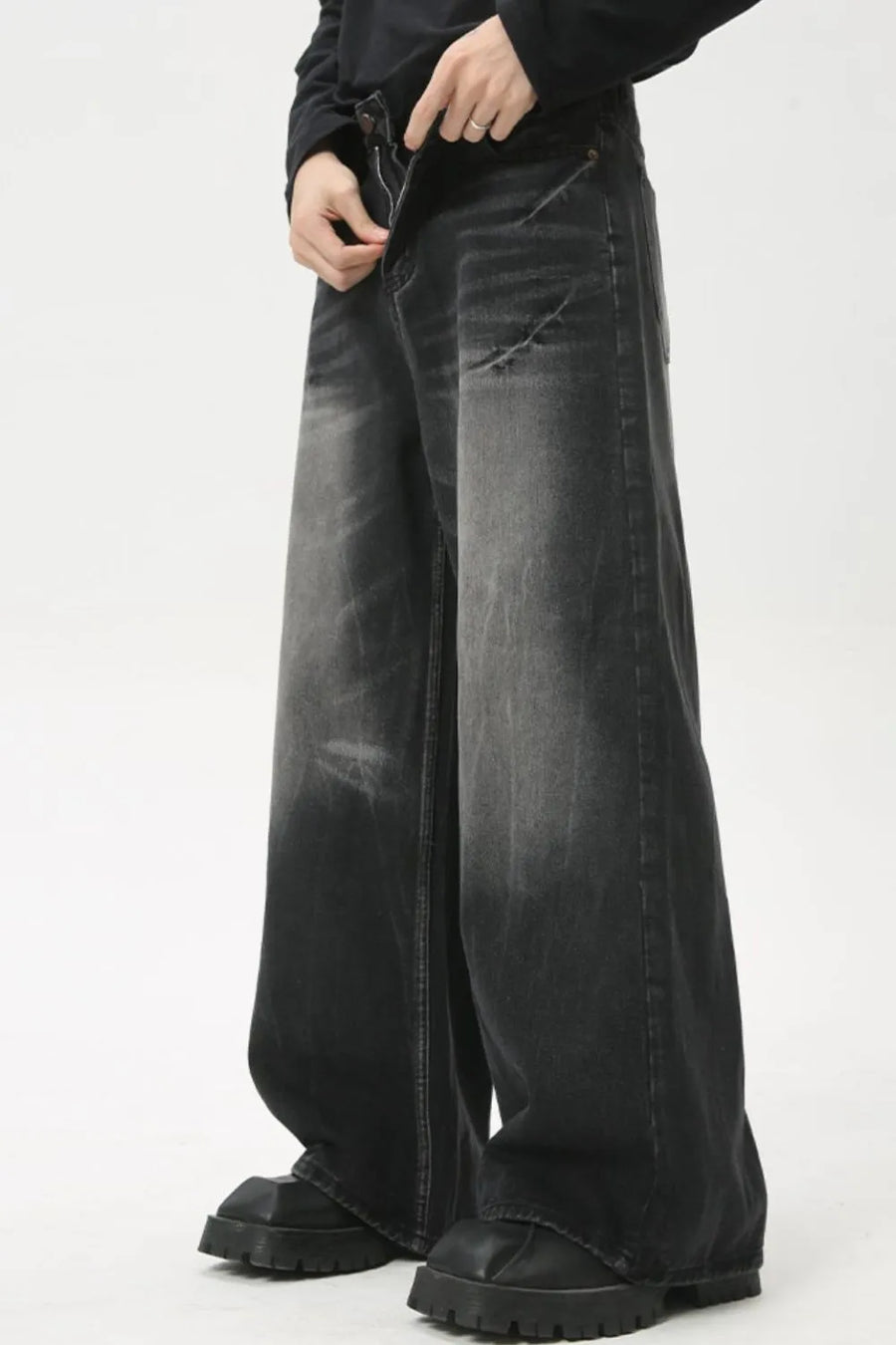 Dark wash denim jeans with a wide leg and whiskered details.