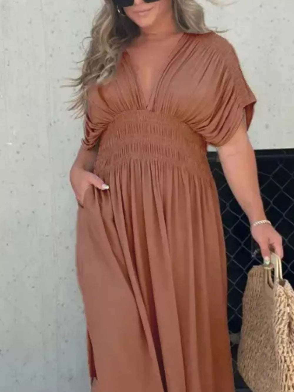 Brown V-neck maxi dress with smocked waist and dolman sleeves, featuring pockets.