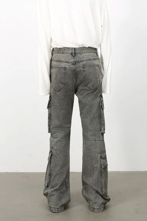 Acid wash flared cargo denim pants in medium, featuring multiple pockets and a relaxed fit.