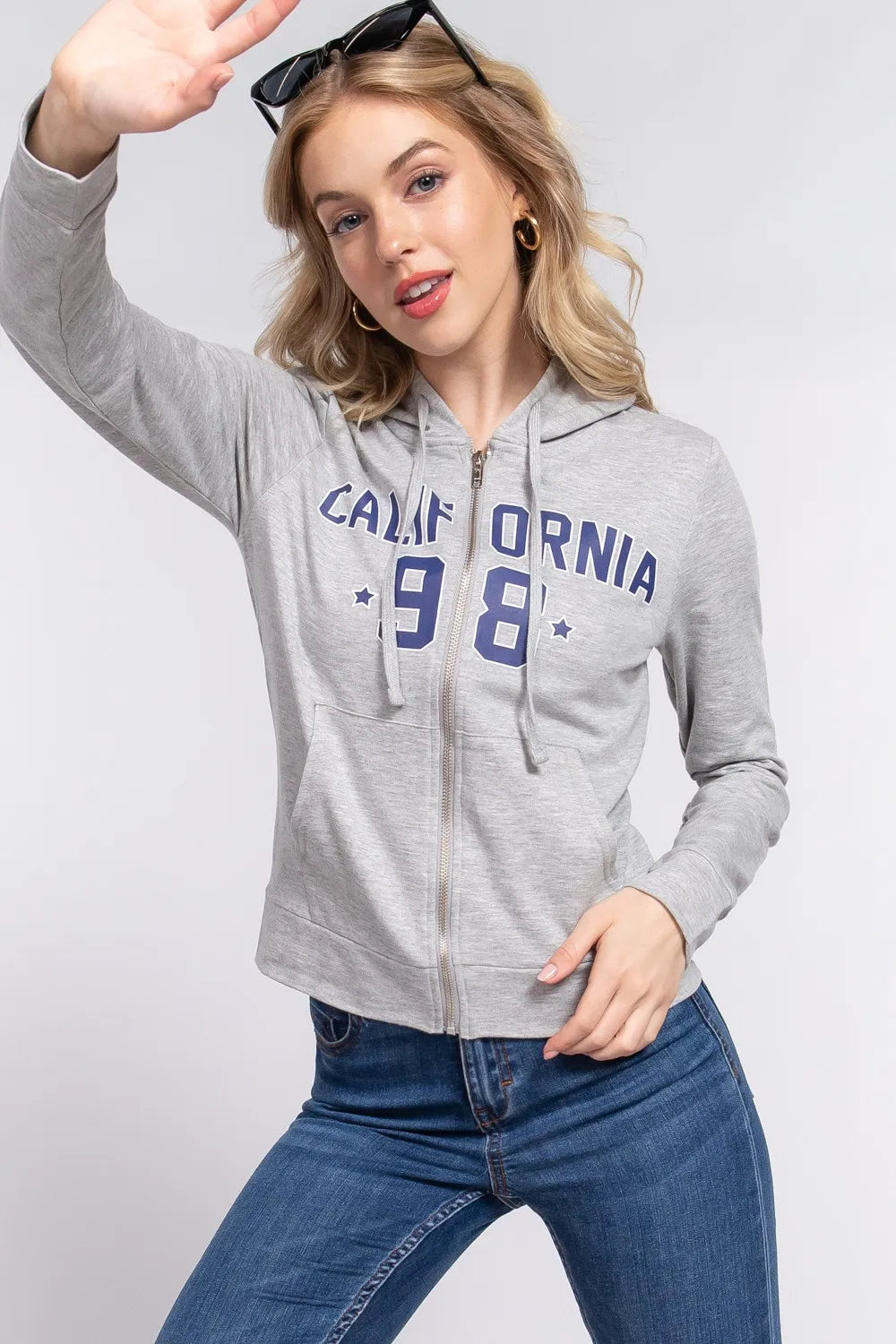 Grey zip-up hoodie with California '98 graphic, drawstring hood, and front pockets.