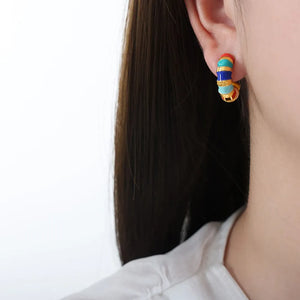 Gold hoop earrings with colorful segmented enamel and gold details.