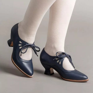 Navy leather Mary Jane heels with cutouts and lace-up detail