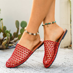 Red woven mule sandals with a net-like pattern and brown sole.