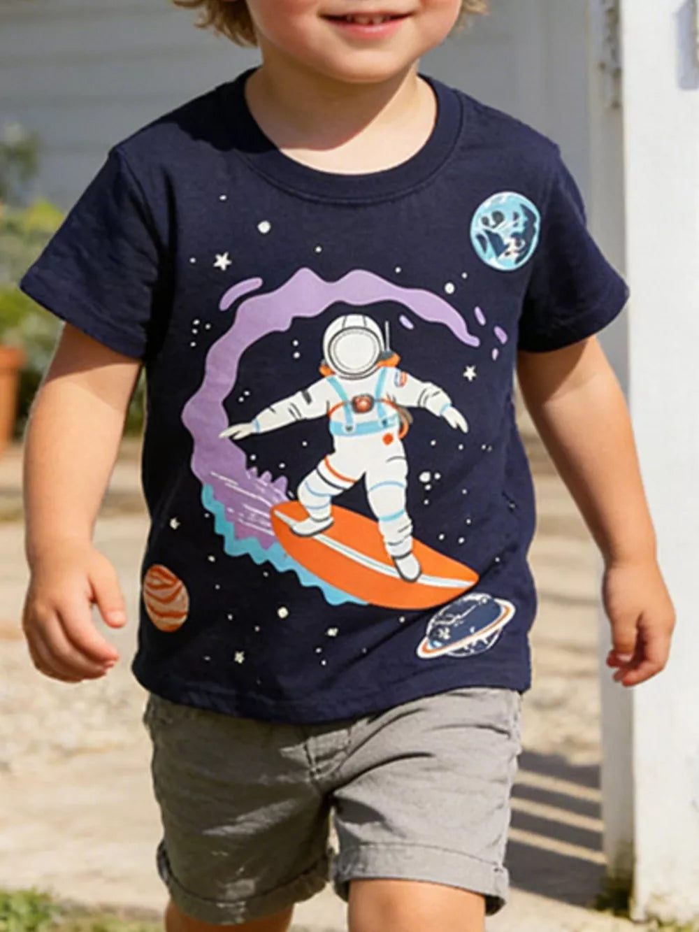 Navy cotton t-shirt with astronaut surfing in space graphic for toddlers