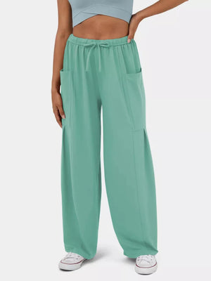 Light Green wide-leg maternity pants with drawstring waist and cargo pockets.