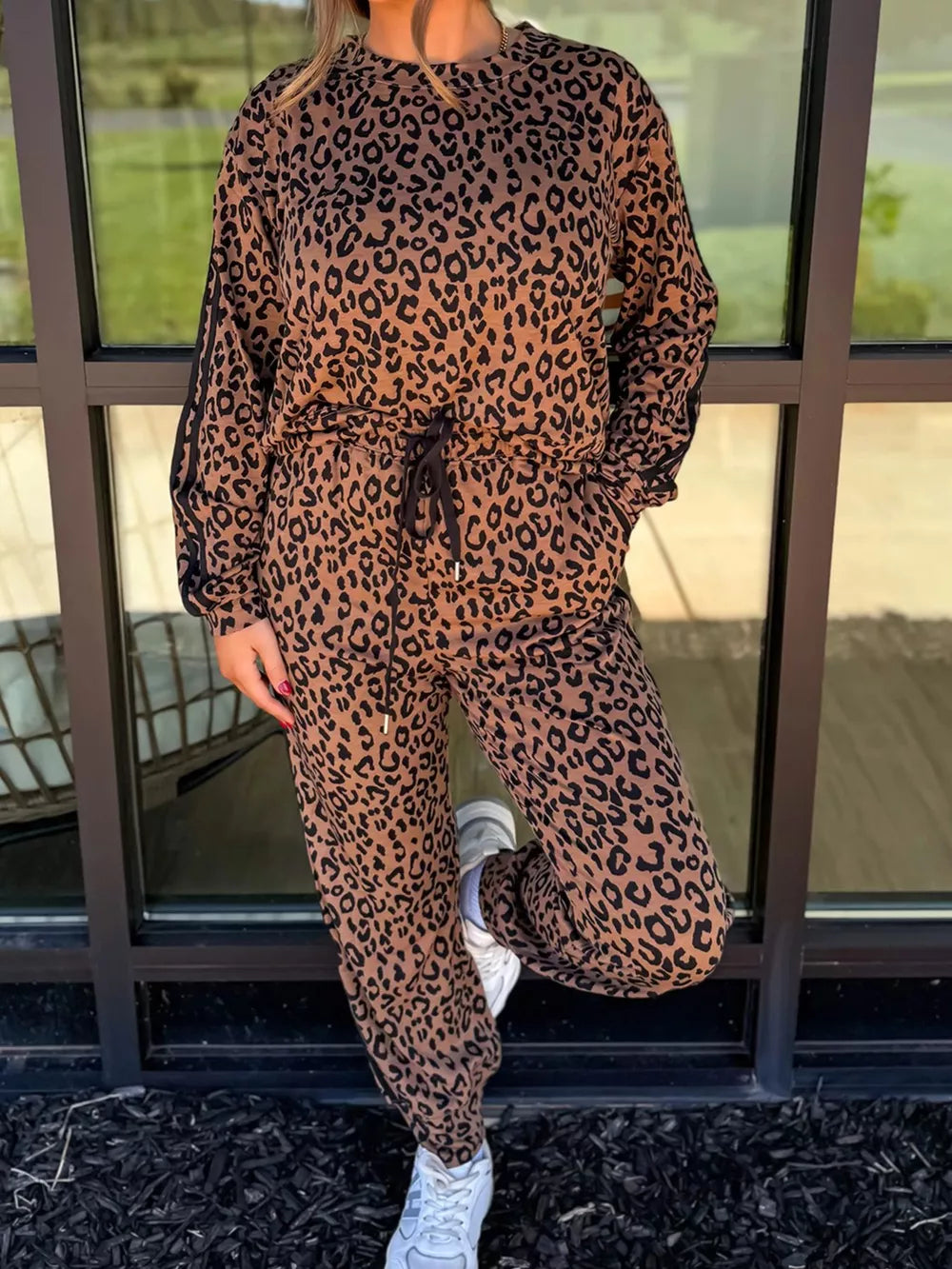 Leopard print loungewear set with drawstring joggers and long sleeve top.