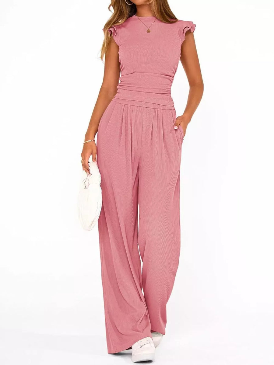 Pink maternity two-piece ensemble with ruffled cap sleeves and wide-leg pants.