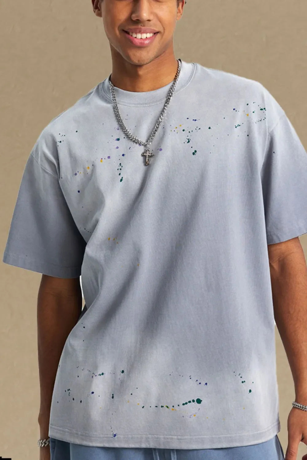 Oversized gray t-shirt with multicolor paint splatter detail and crew neck.