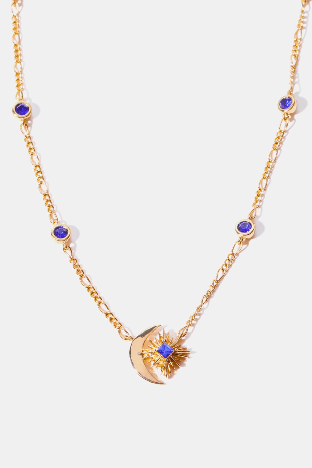 Gold celestial necklace with moon, sunburst, and blue gems