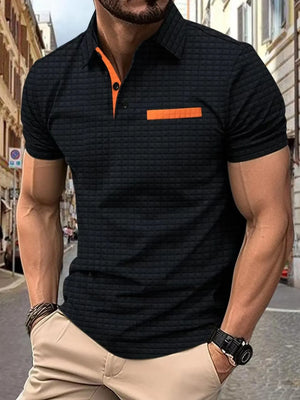 Black textured polo shirt with orange contrast collar and pocket detail.