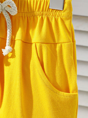 Yellow cotton baby shorts with drawstring and pocket detail