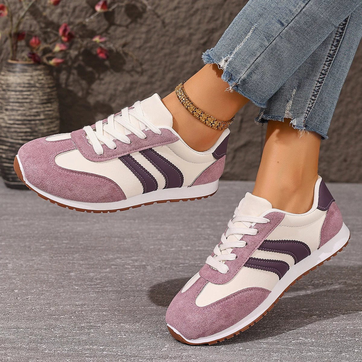 Two-tone suede lace-up sneakers in pink purple with white and dark purple accents.