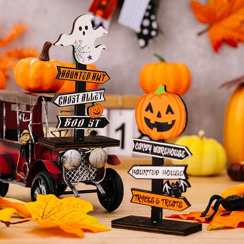 Spooky signpost decor with ghost, pumpkins, and Halloween destinations like Haunted Hwy, Ghost Alley, Boo St, Candy