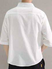 White cotton button-down shirt with roll-up sleeves and a chest pocket.
