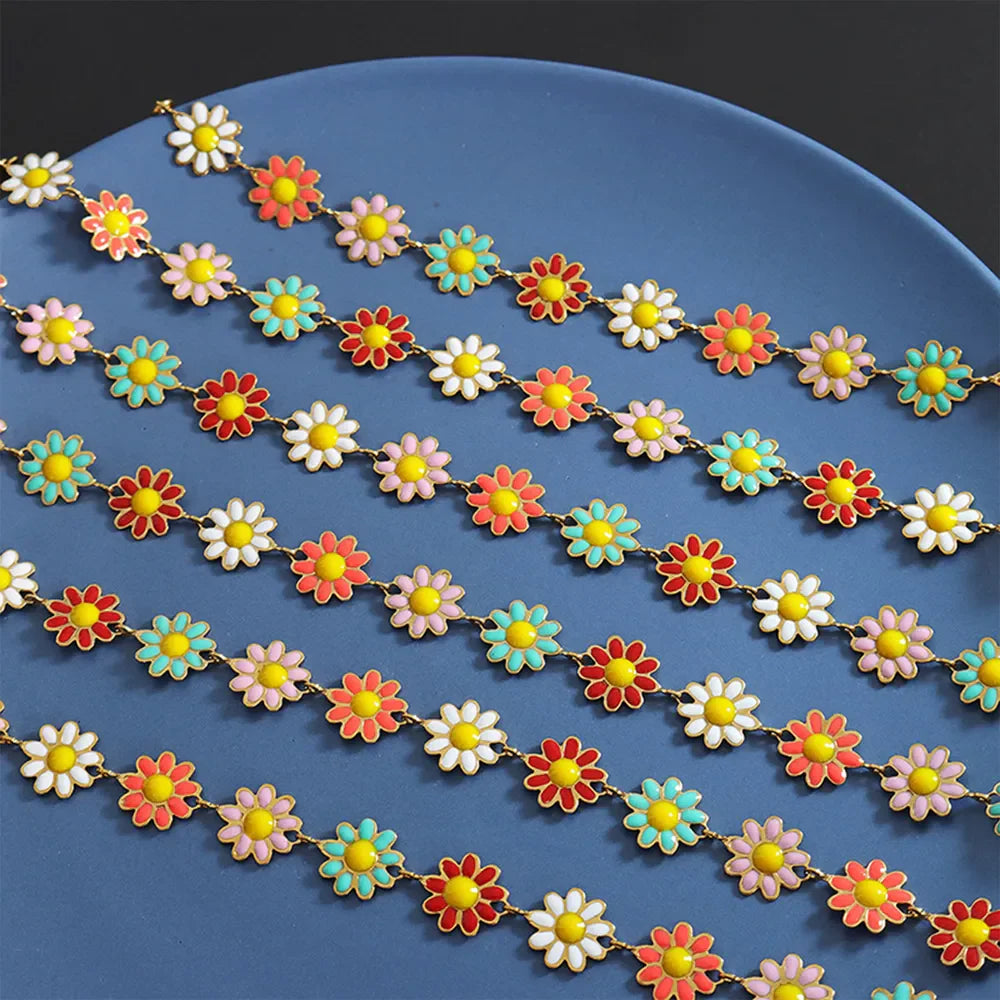 Daisy chain enamel collar necklace with gold chain and colorful flower charms.