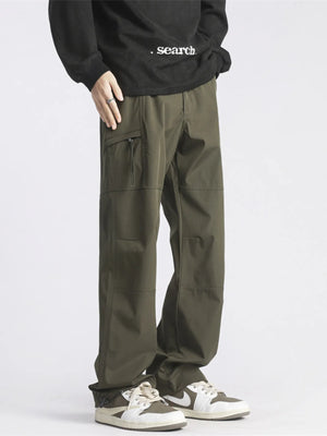 Relaxed fit green cargo pants with zip pocket detail and casual styling.
