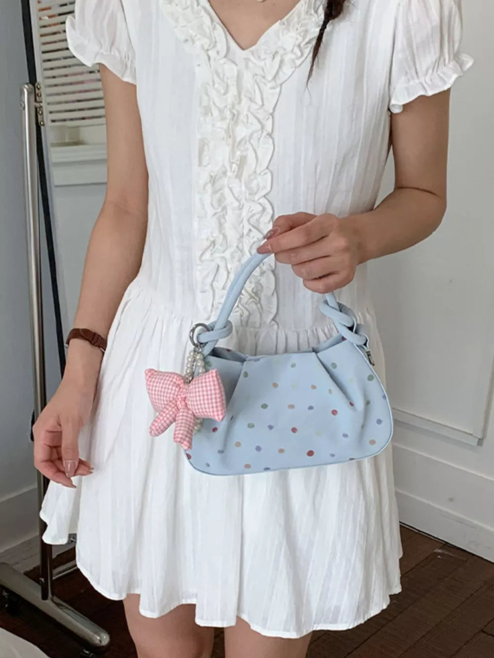 crossbody bag in light blue featuring bow charm and relaxed fit