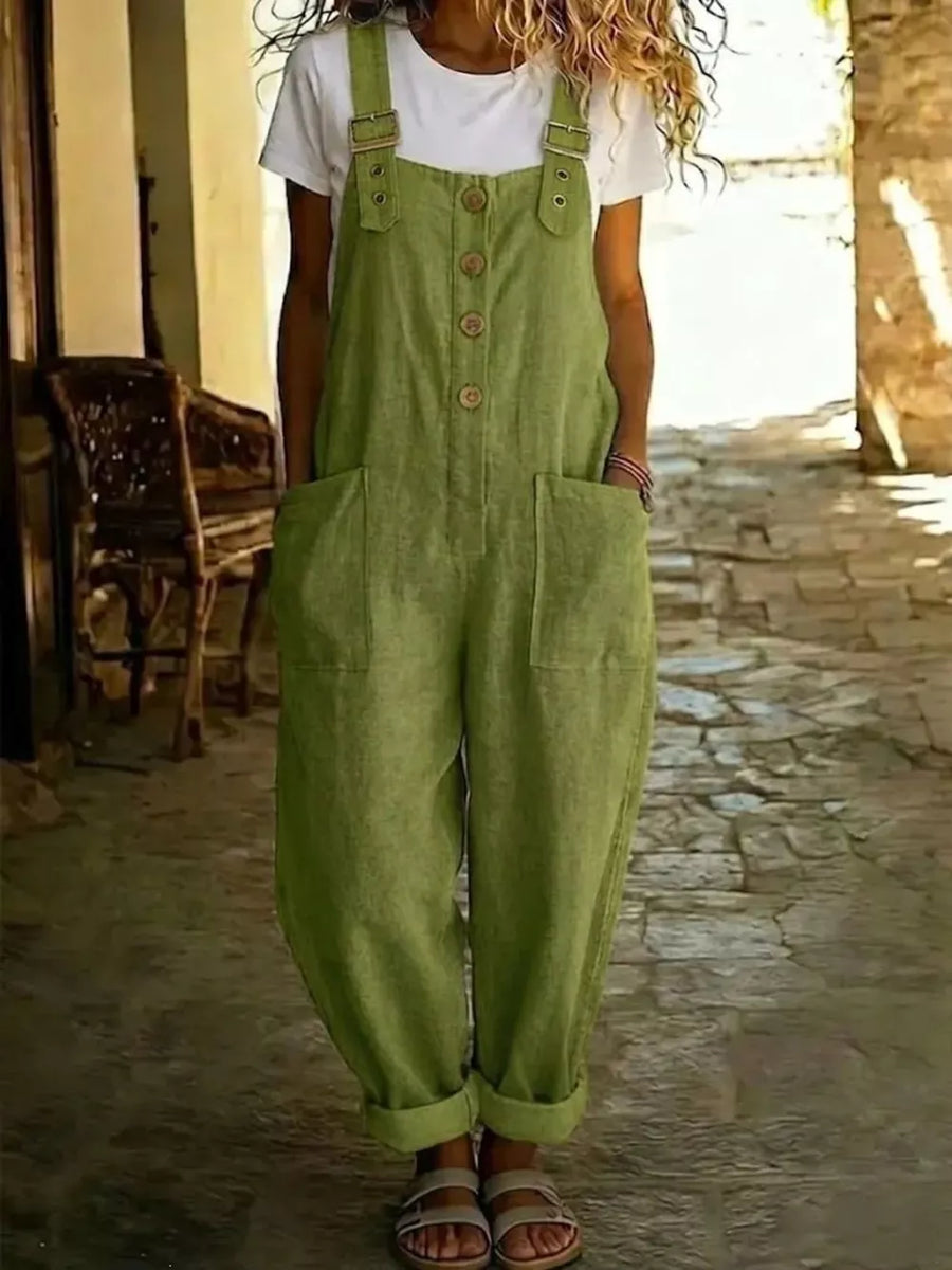 Army green wide leg romper with buttons and pockets, styled with a white tee.
