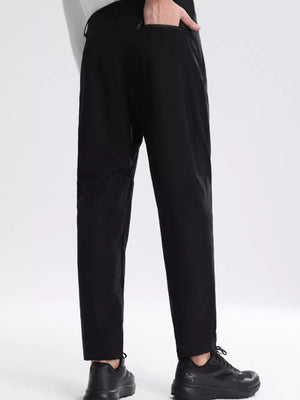 Black sweatpants with zippered pockets, straight leg, and elastic cuffs.