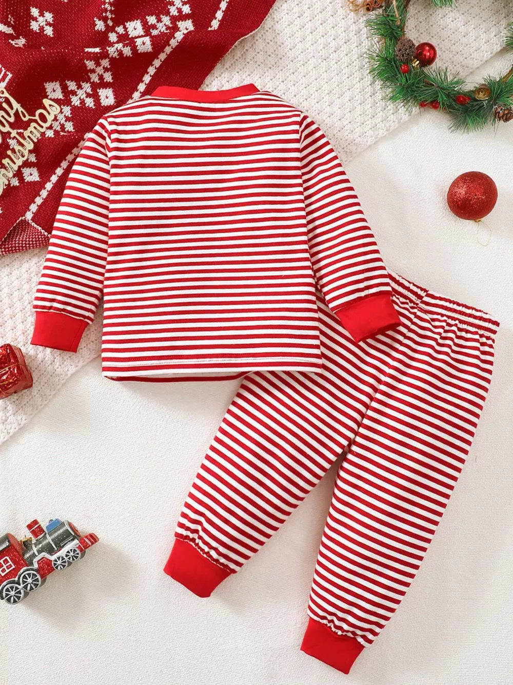Baby red and white striped pajama set with red cuffs and neckline.