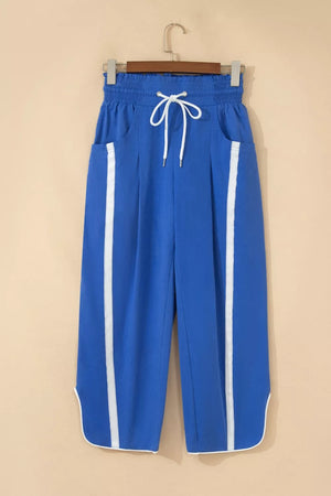 Blue smocked waist cropped casual pants with white side stripes and drawstring.