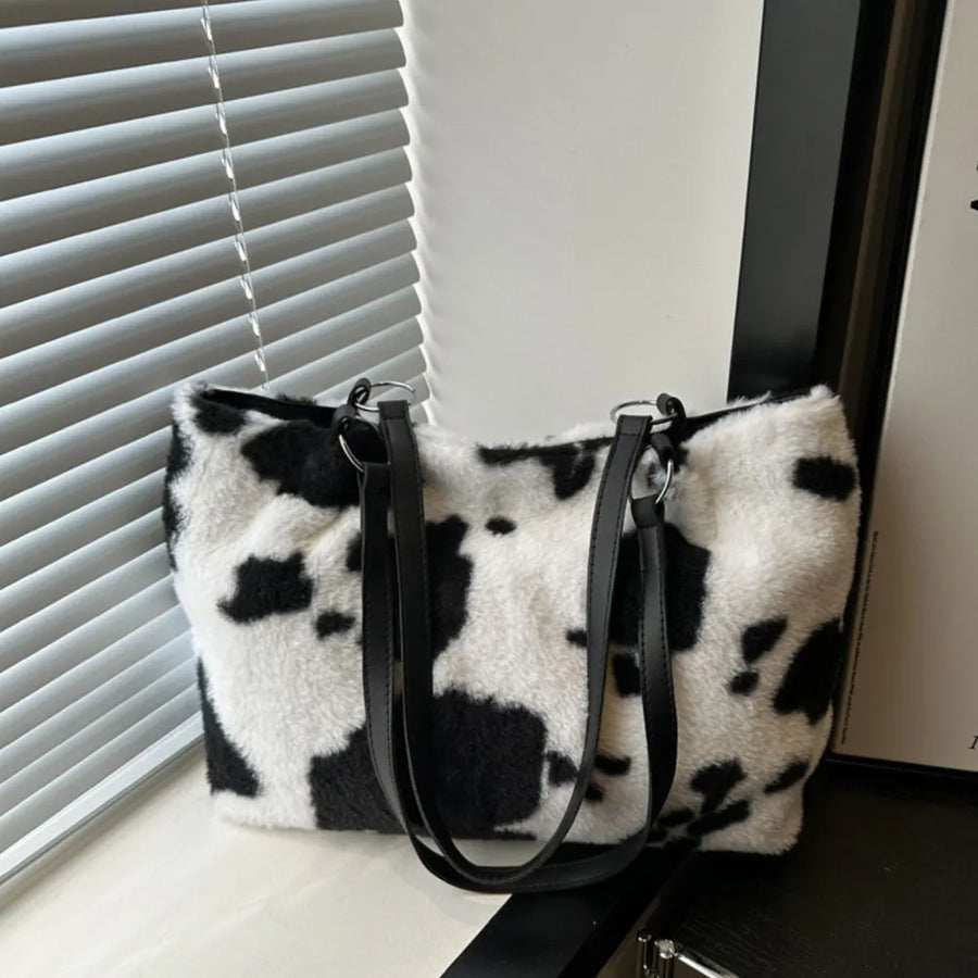 Cowhide print faux fur shopper bag with black faux leather straps.
