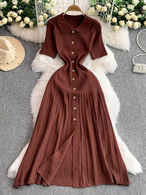 Brown ribbed knit midi dress with collar, short sleeves, button detail, and a front slit.