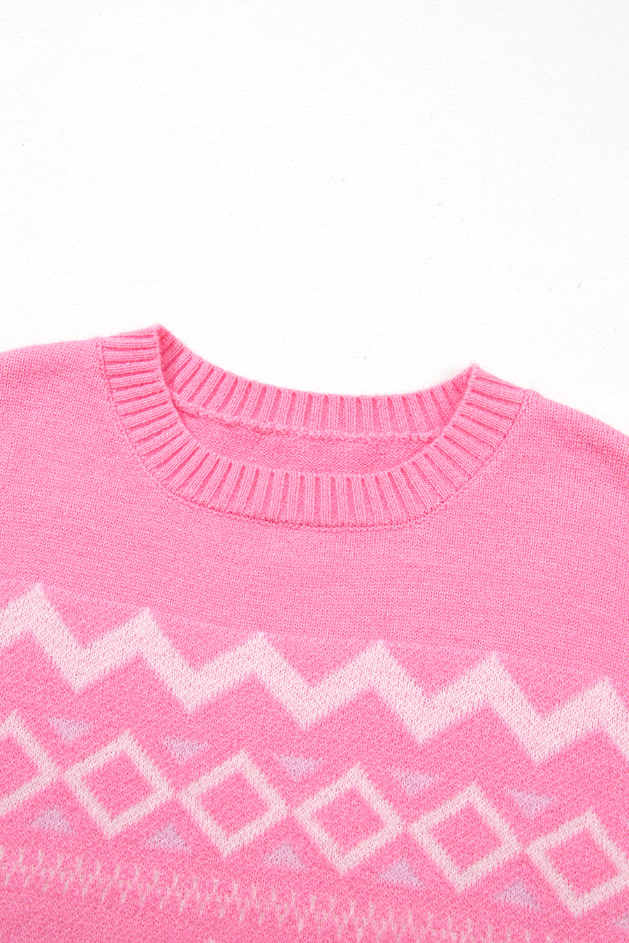 Pink acrylic knit sweater with geometric colorblock pattern and crew neck.