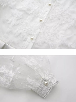 White lace maxi dress with pearl buttons and lantern sleeves.