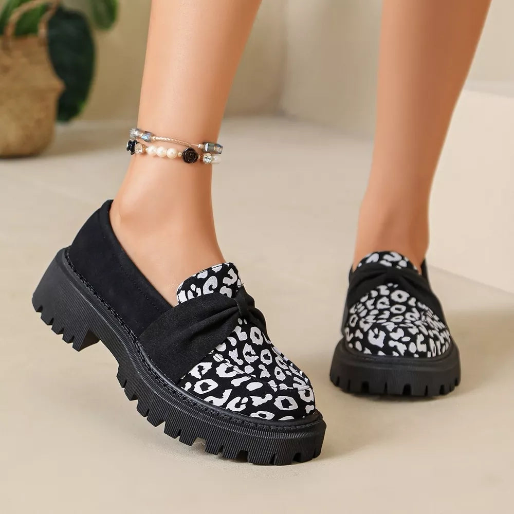white loafers featuring round toe and leopard-print