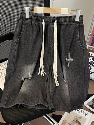Black distressed denim shorts for men with drawstring waist and frayed details.