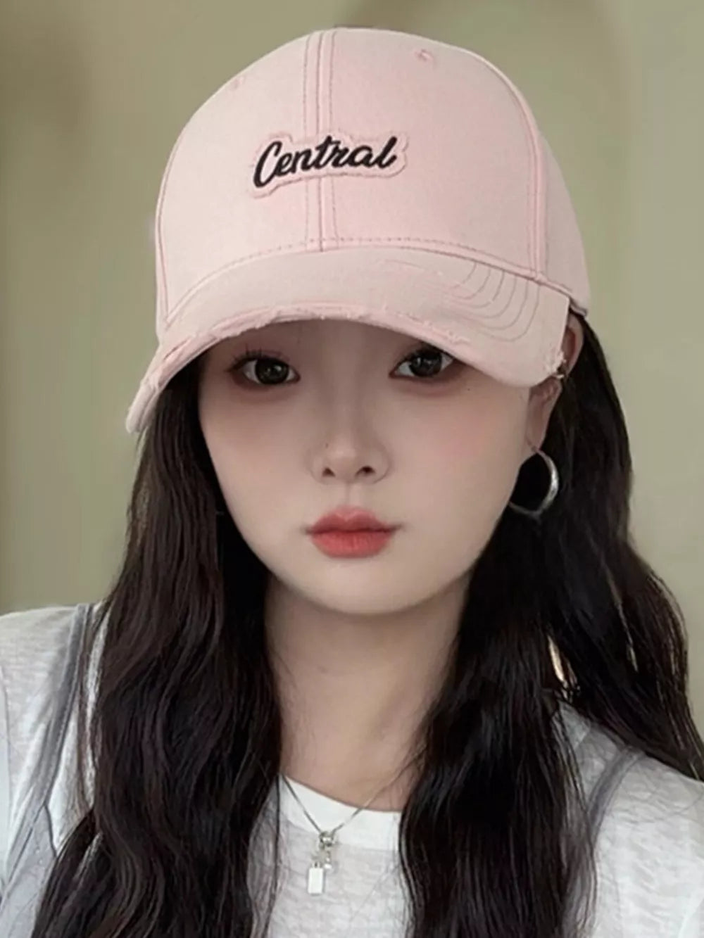 Pink baseball cap with distressed brim and embroidered "Central" text