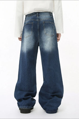 Faded wash balloon leg jeans in medium blue denim with a relaxed fit and distressed details.