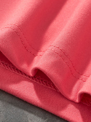 Coral t-shirt with ruffled sleeves and double-stitched seams.