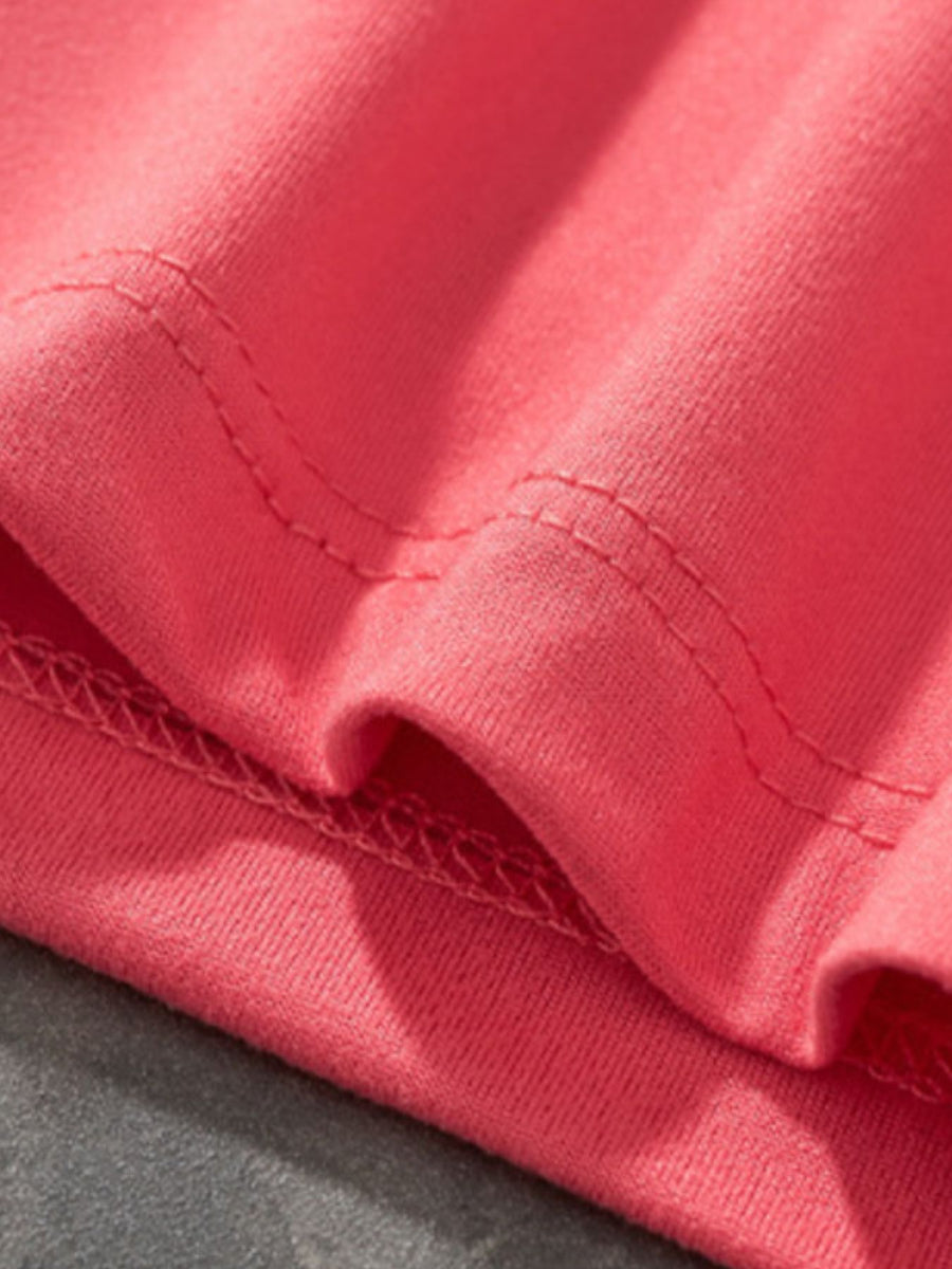 Coral t-shirt with ruffled sleeves and double-stitched seams.