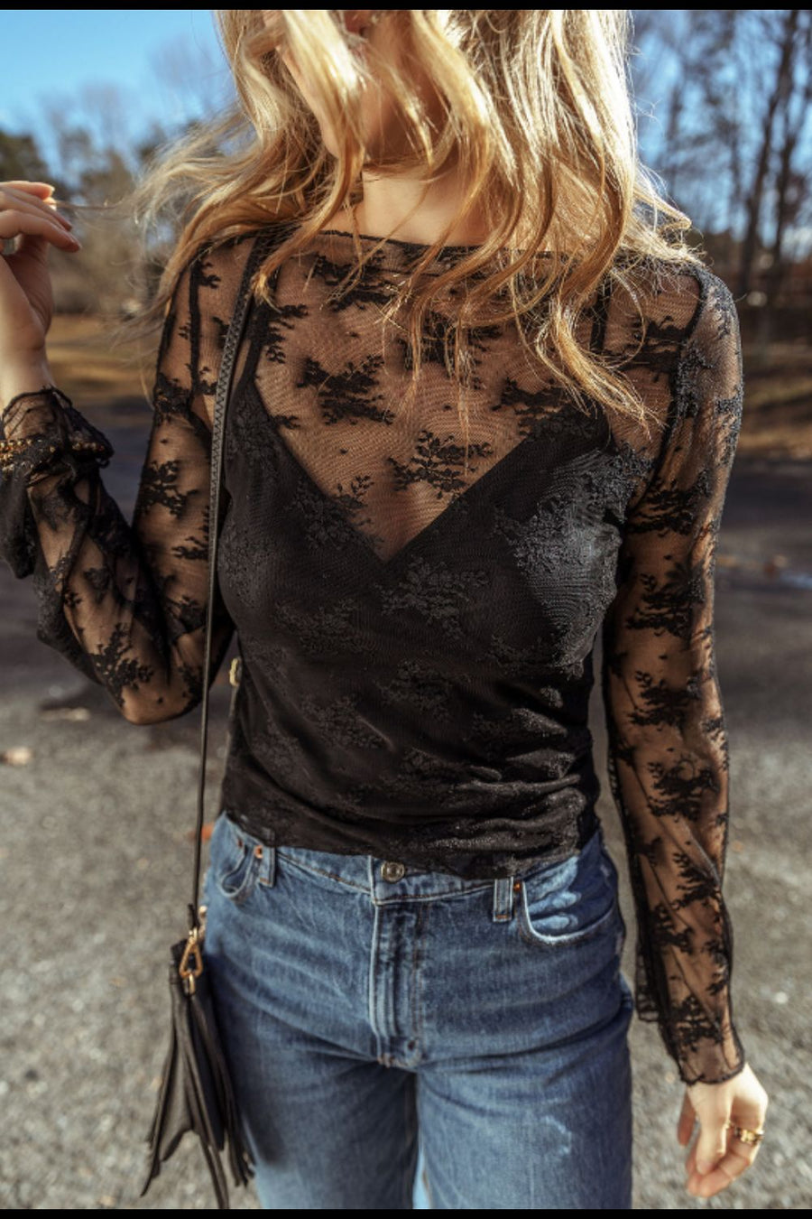 Black floral lace bodysuit with bell sleeves and a V-neck cami.