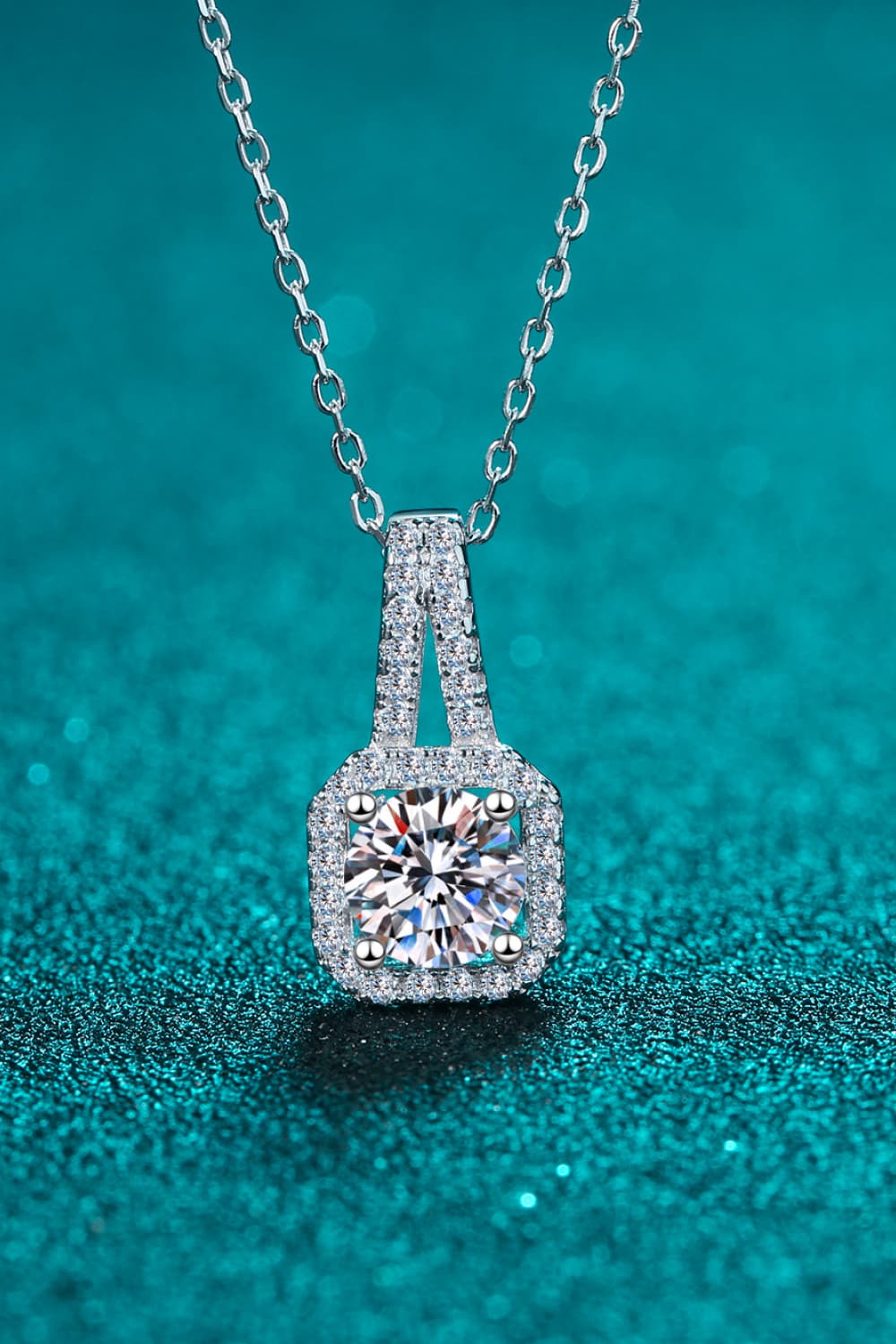 Silver cushion halo moissanite pendant necklace with a detailed chain.