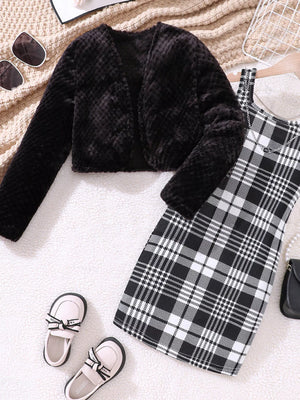 Black fuzzy cardigan with long sleeves and a plaid dress.