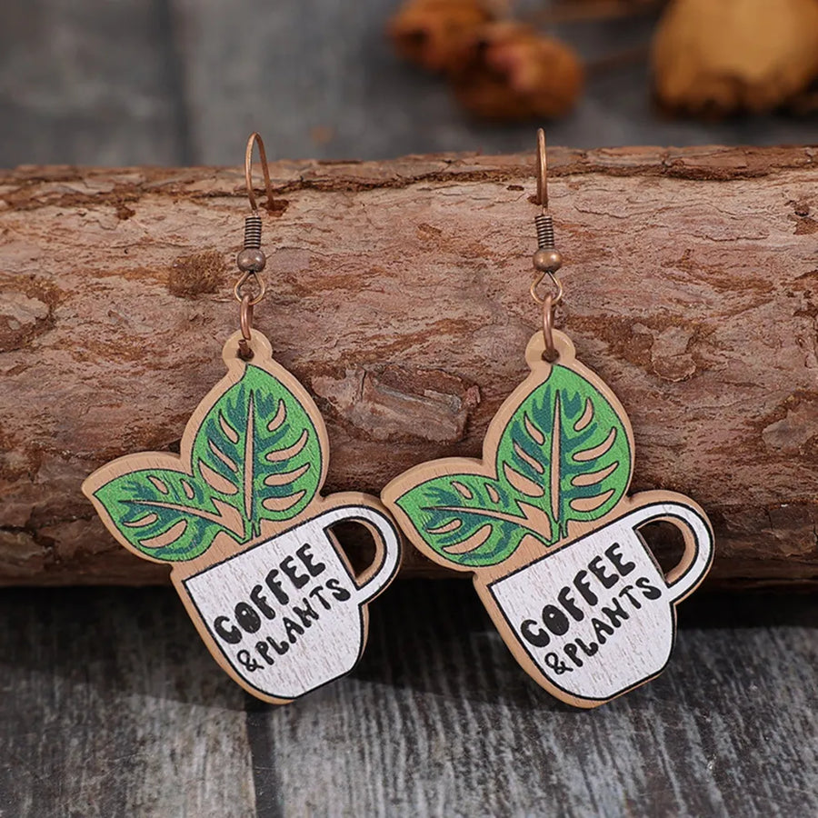 Wooden drop earrings with green leaves and coffee cup graphic, text reads Coffee & Plants