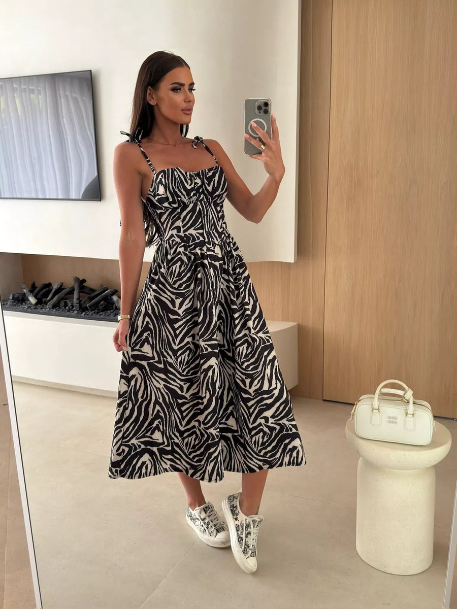 Floral tie-strap midi dress in zebra print with a-line skirt and sweetheart neckline.