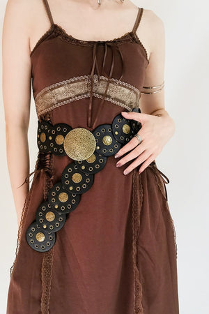 Black faux leather belt with gold discs and grommets, statement buckle