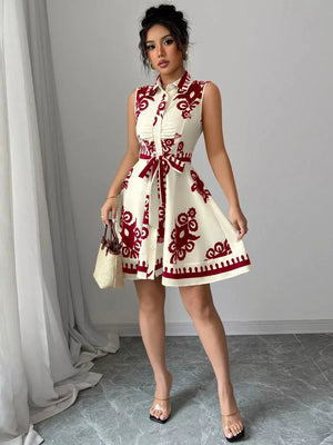 Cream and red print shirtdress with tie waist and button front.