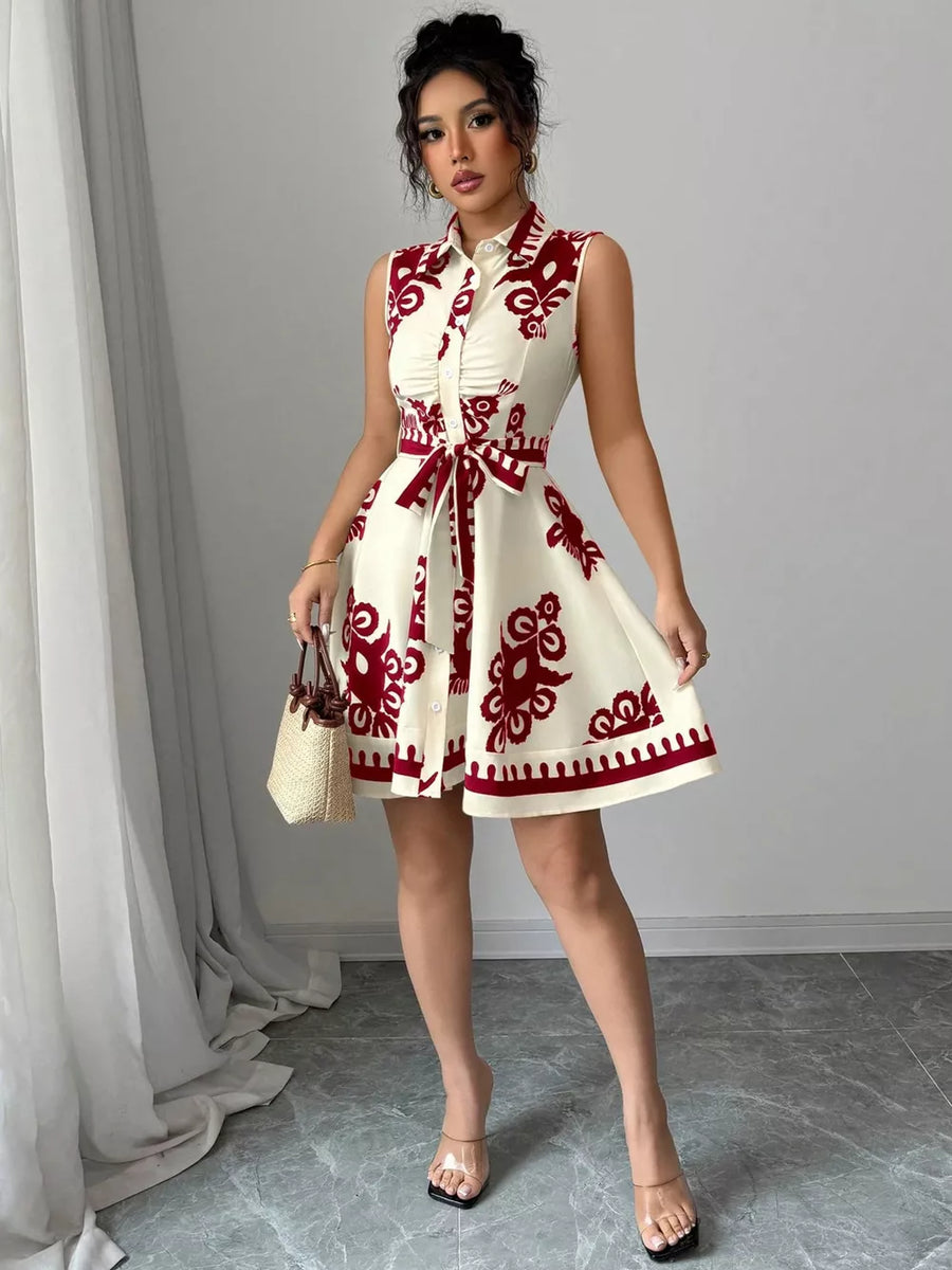 Cream and red print shirtdress with tie waist and button front.