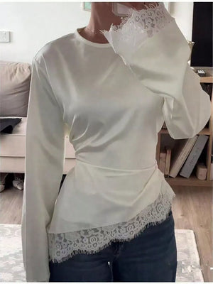blouse in ivory featuring lace detail and relaxed fit